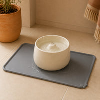 Gros plan du rebord du tapis retenant l'eau de la fontaine